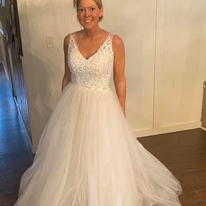 Never worn. No alterations done. Size 4.  Hidden zipper on side. Built in bra.